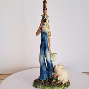 Ceramic farmer with pig sculpture.